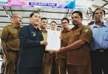 Bupati Karo Terkelin Brahmana menyerahkan SK kepada kepala desa batukarang dan PJ Kades Batukarang Kuta